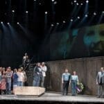 From right to left: Valerian Ruminski (Rocco), Neil Craighead (Don Fernando), Miriam Khalil (Marzelline), Owen McCausland (Jaquino), Brent Turner (Florestan), Aviva Fortunata (Leonore/Fidelio) and chorus in Pacific Opera Victoria’s Fidelio. Photo: Emily Cooper